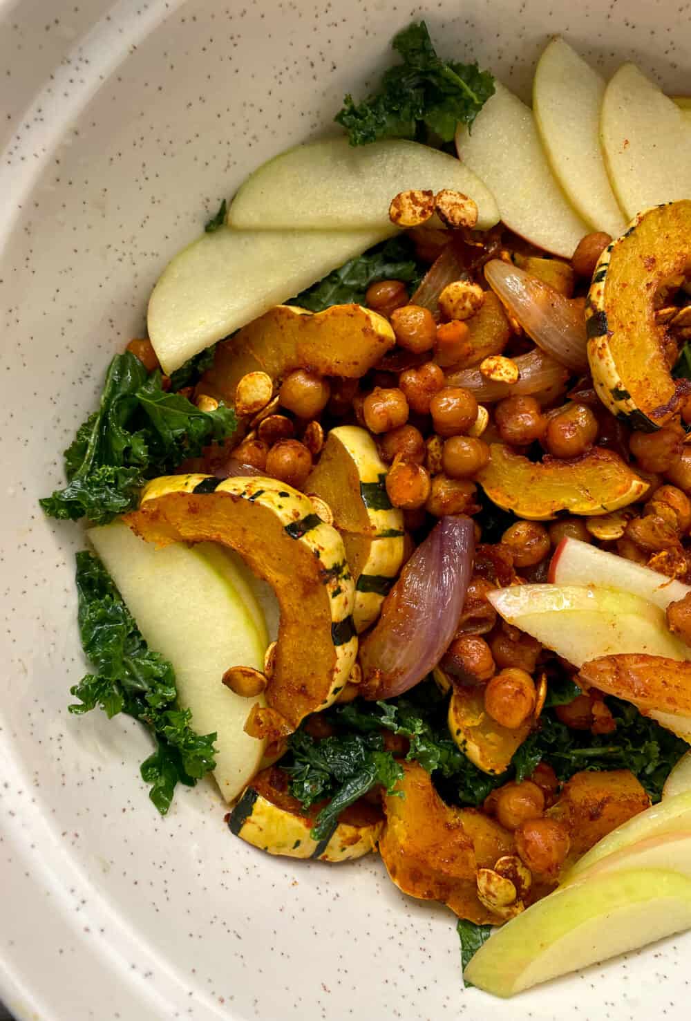 A big salad with kale, pickled apples, roasted delicata squash, smoky spiced chickpeas and creamy tahini-apple dressing.